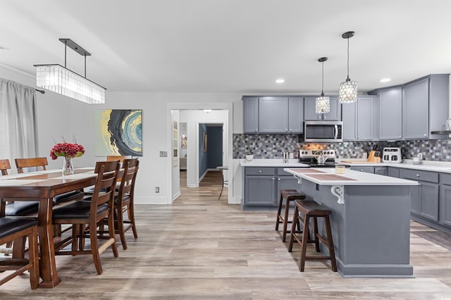 241 Fannie B Rd, Conway, SC 29526 - kitchen featuring gray cabinetry, stainless steel appliances, light countertops, a kitchen island, and tasteful backsplash