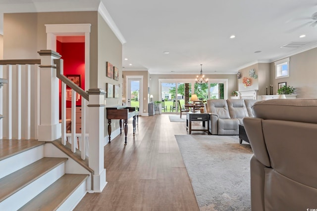 1106 Bluffton Ct, Myrtle Beach, SC 29579 - living area featuring stairway, crown molding, recessed lighting, wood finished floors, and a chandelier