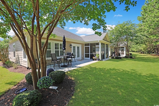 428 Arlington Cir, Murrells Inlet, SC 29576 - rear view of house featuring a patio area, a lawn, a shingled roof, and a sunroom