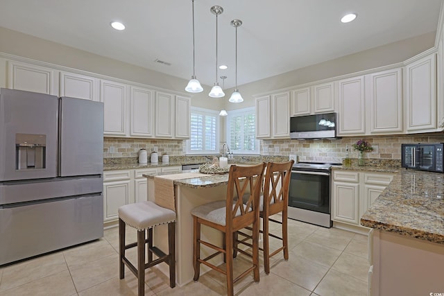428 Arlington Cir, Murrells Inlet, SC 29576 - kitchen with appliances with stainless steel finishes, light tile patterned floors, white cabinetry, backsplash, and recessed lighting