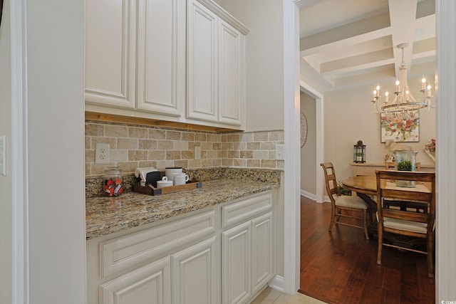 428 Arlington Cir, Murrells Inlet, SC 29576 - kitchen featuring coffered ceiling, backsplash, light wood-style flooring, a chandelier, and light stone countertops
