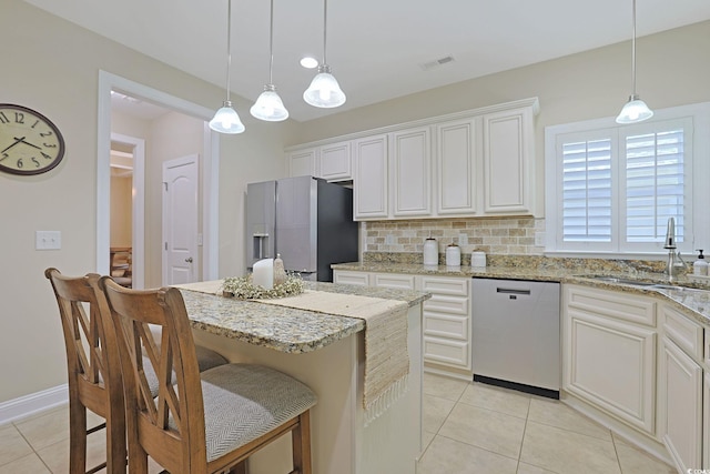 428 Arlington Cir, Murrells Inlet, SC 29576 - kitchen featuring stainless steel dishwasher, fridge with ice dispenser, light tile patterned flooring, and a kitchen island