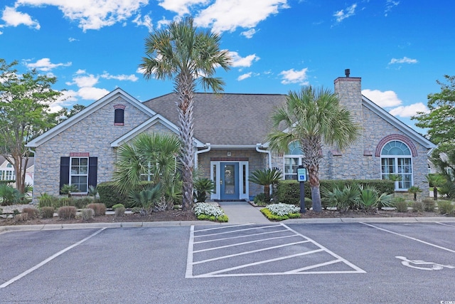 428 Arlington Cir, Murrells Inlet, SC 29576 - view of front of house with stone siding, a chimney, and uncovered parking