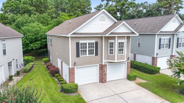 670 2nd Ave N, North Myrtle Beach, SC 29582 - view of front of house with an attached garage, brick siding, driveway, a front yard, and roof with shingles