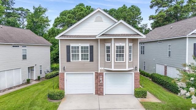670 2nd Ave N, North Myrtle Beach, SC 29582 - view of front facade with a front yard, driveway, brick siding, and an attached garage