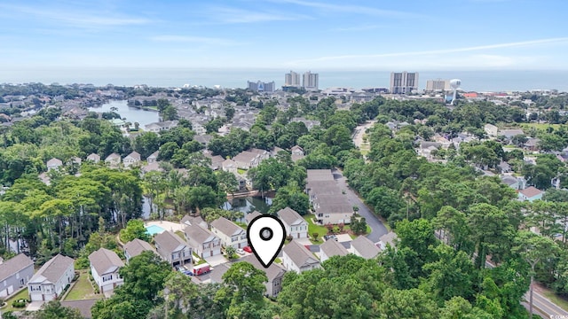 670 2nd Ave N, North Myrtle Beach, SC 29582 - aerial view of property and surrounding area with a nearby body of water and a tree filled landscape