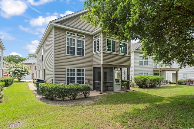 670 2nd Ave N, North Myrtle Beach, SC 29582 - back of property with a sunroom and a yard