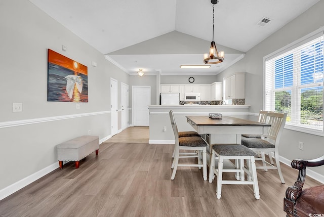 300 Kiskadee Loop Unit K, Conway, SC 29526 - dining area featuring light wood-type flooring, a chandelier, and lofted ceiling