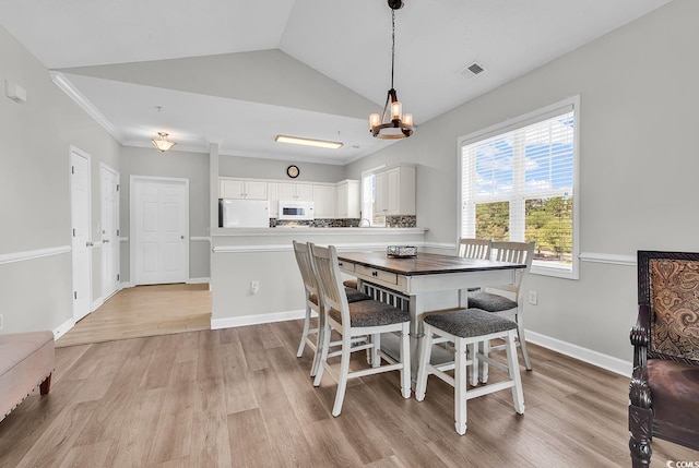 300 Kiskadee Loop Unit K, Conway, SC 29526 - dining space featuring light wood finished floors, a chandelier, and vaulted ceiling