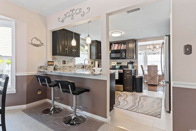 1575 Victoria Ln, Myrtle Beach, SC 29577 - kitchen featuring stainless steel appliances, a kitchen breakfast bar, healthy amount of natural light, and a peninsula