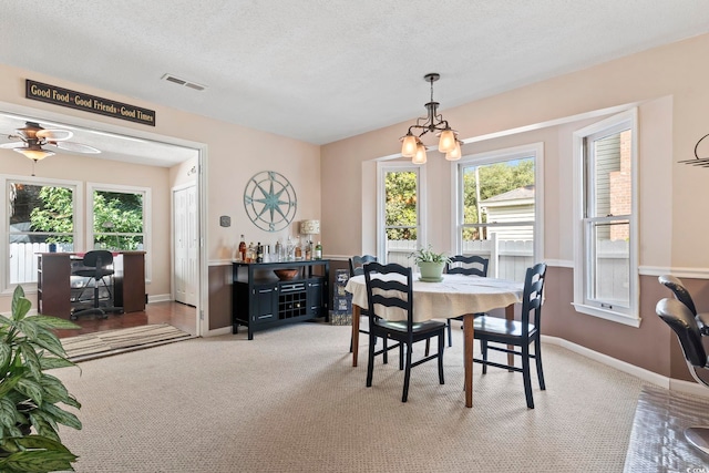 1575 Victoria Ln, Myrtle Beach, SC 29577 - carpeted dining area featuring a desk, a textured ceiling, a chandelier, and a ceiling fan