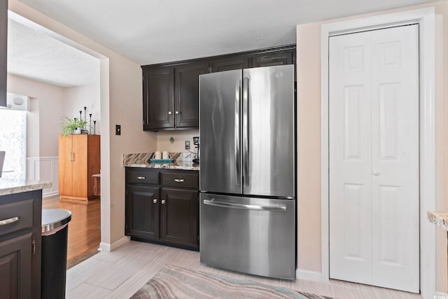 1575 Victoria Ln, Myrtle Beach, SC 29577 - kitchen with freestanding refrigerator and light stone countertops