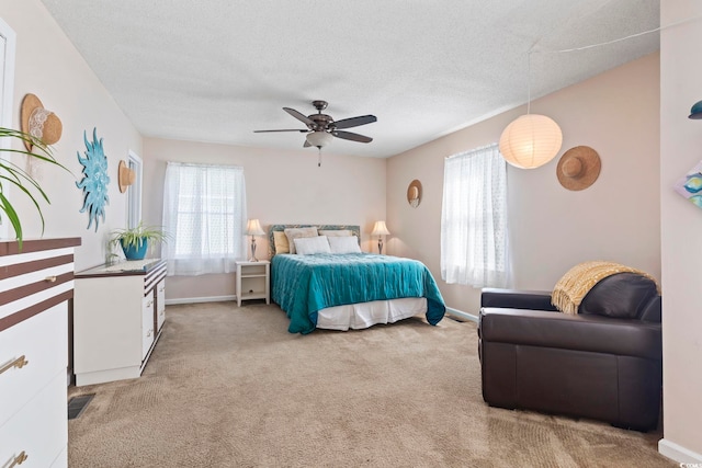 1575 Victoria Ln, Myrtle Beach, SC 29577 - bedroom featuring multiple windows, light colored carpet, a ceiling fan, and a textured ceiling