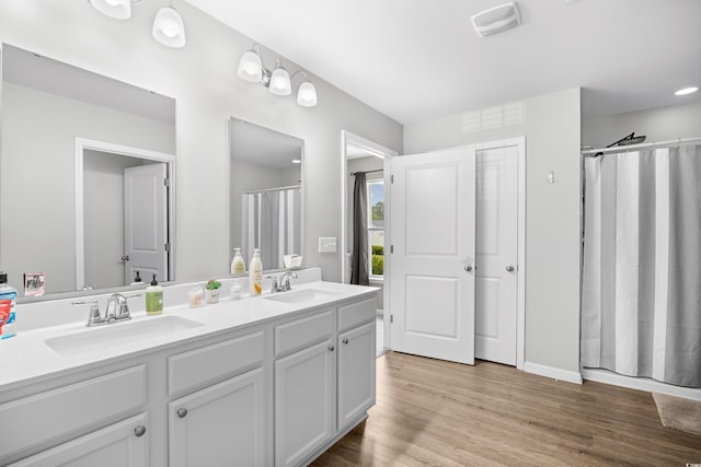 317 Truce St, Myrtle Beach, SC 29588 - full bath with double vanity, wood finished floors, and a shower with shower curtain