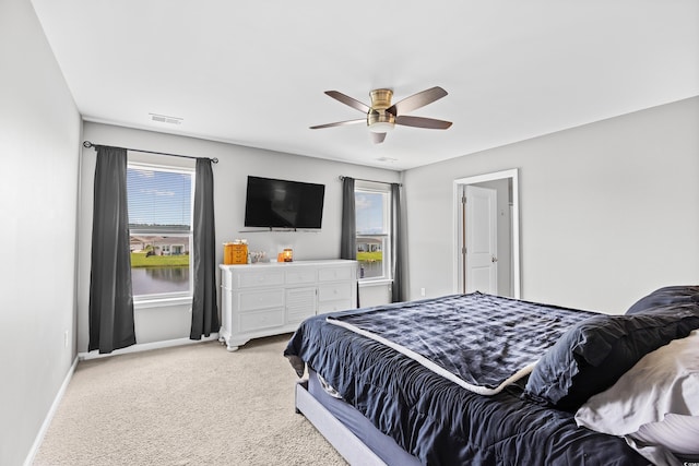 317 Truce St, Myrtle Beach, SC 29588 - bedroom featuring light colored carpet, multiple windows, and a ceiling fan