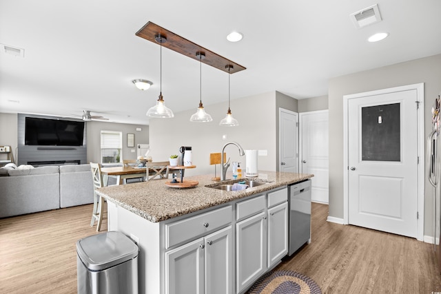 317 Truce St, Myrtle Beach, SC 29588 - kitchen featuring dishwasher, light wood-style floors, a ceiling fan, a kitchen island with sink, and pendant lighting