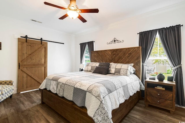 2588 Long Ave, Conway, SC 29526 - bedroom with a barn door, dark wood-style flooring, crown molding, and ceiling fan