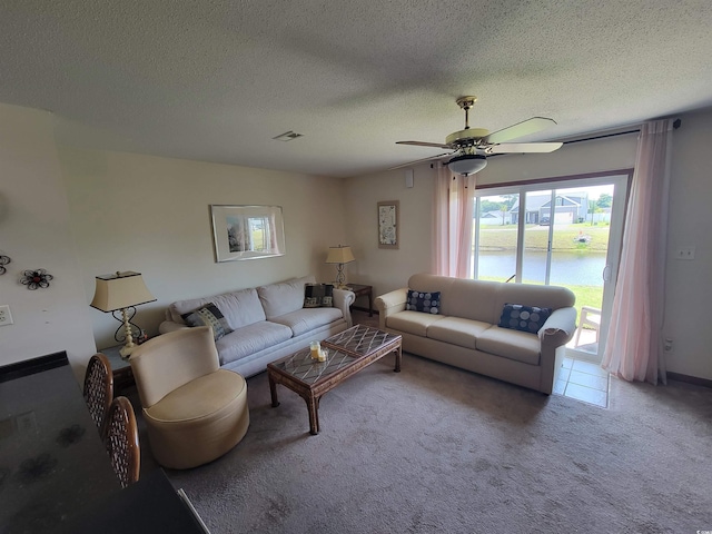 207 Double Eagle Dr Unit E-1, Surfside Beach, SC 29575 - carpeted living area featuring ceiling fan, a textured ceiling, and a water view