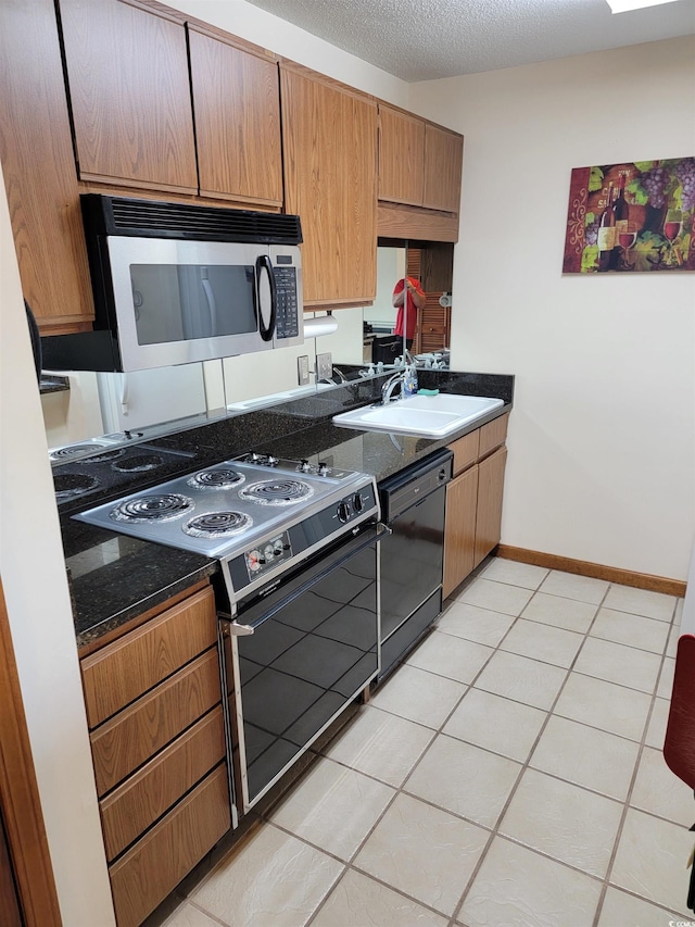 207 Double Eagle Dr Unit E-1, Surfside Beach, SC 29575 - kitchen featuring black dishwasher, range with electric stovetop, stainless steel microwave, and light tile patterned flooring