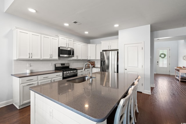 405 Spring View Ct, Little River, SC 29566 - kitchen featuring stainless steel appliances, decorative backsplash, dark wood-style floors, white cabinets, and recessed lighting