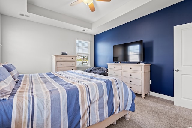 405 Spring View Ct, Little River, SC 29566 - bedroom featuring light colored carpet, a tray ceiling, and a ceiling fan