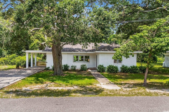4325 Ellis Ave, Little River, SC 29566 - view of front facade featuring asphalt driveway, a carport, and a front lawn