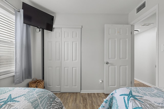 920 N Waccamaw Dr Unit 2310, Murrells Inlet, SC 29576 - bedroom featuring a closet, wood finished floors, and multiple windows