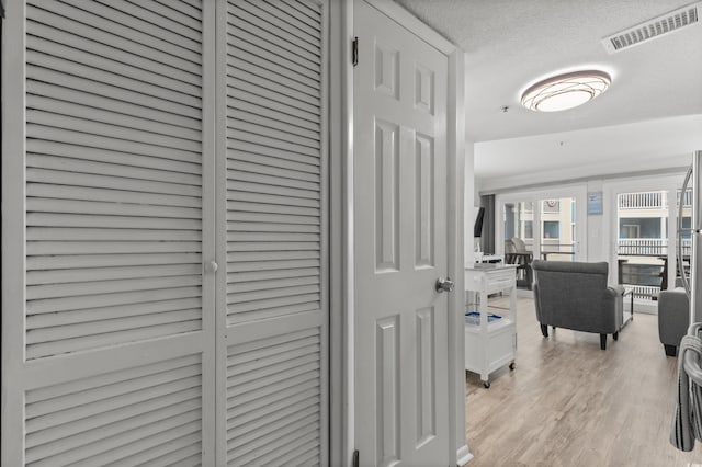 920 N Waccamaw Dr Unit 2310, Murrells Inlet, SC 29576 - hallway featuring light wood-type flooring and a textured ceiling