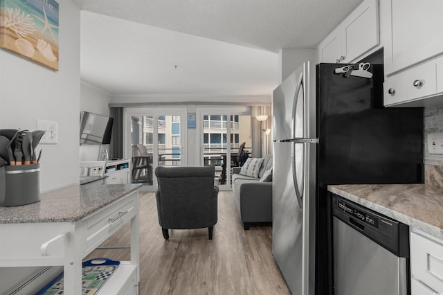 920 N Waccamaw Dr Unit 2310, Murrells Inlet, SC 29576 - kitchen featuring stainless steel appliances, light wood-style flooring, white cabinetry, light stone countertops, and ornamental molding
