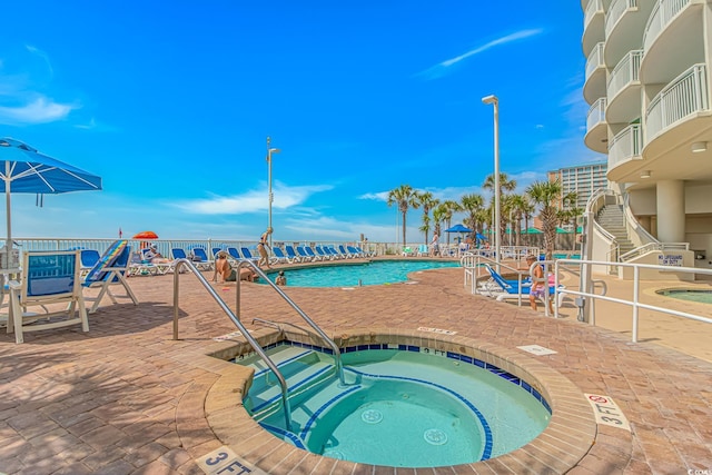 201 S Ocean Blvd Unit 616, Myrtle Beach, SC 29577 - community pool featuring a hot tub and a patio