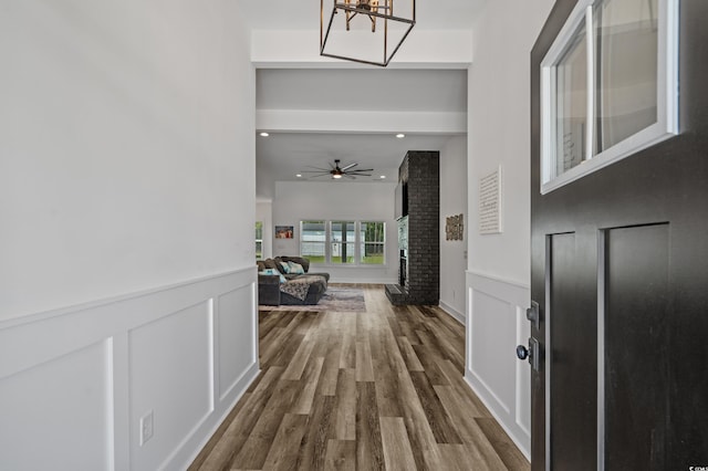 1253 Kenworth Cir, Conway, SC 29526 - entrance foyer featuring a fireplace, dark wood-style floors, a chandelier, a ceiling fan, and recessed lighting