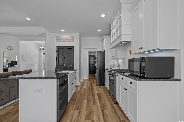 1253 Kenworth Cir, Conway, SC 29526 - kitchen with stainless steel appliances, white cabinets, wood finished floors, dark stone counters, and recessed lighting