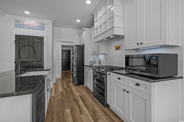 1253 Kenworth Cir, Conway, SC 29526 - kitchen with appliances with stainless steel finishes, premium range hood, dark wood finished floors, white cabinets, and recessed lighting