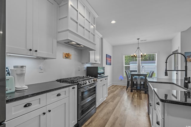 1253 Kenworth Cir, Conway, SC 29526 - kitchen with range with two ovens, a chandelier, light wood finished floors, recessed lighting, and white cabinets