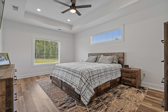 1253 Kenworth Cir, Conway, SC 29526 - bedroom with multiple windows, wood finished floors, a raised ceiling, recessed lighting, and ceiling fan