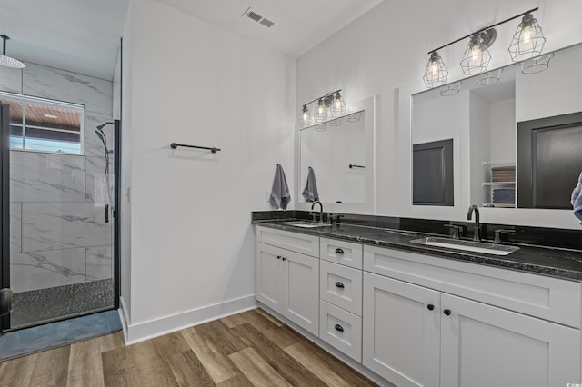 1253 Kenworth Cir, Conway, SC 29526 - bathroom featuring double vanity, a marble finish shower, and wood finished floors