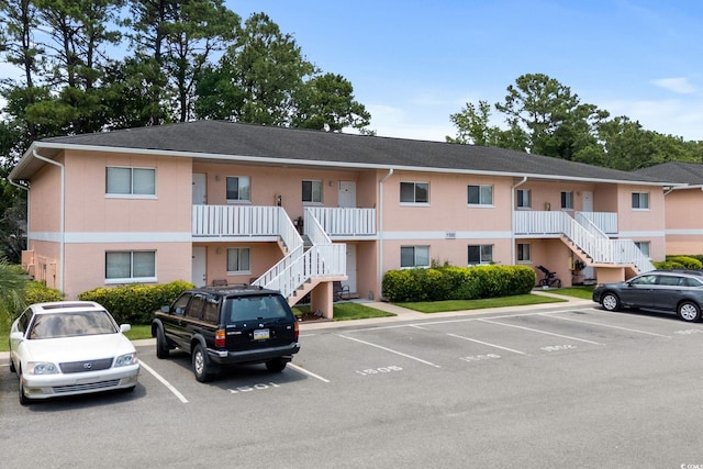 1101 2nd Ave N Unit 1501, Surfside Beach, SC 29575 - view of property featuring stairs and uncovered parking
