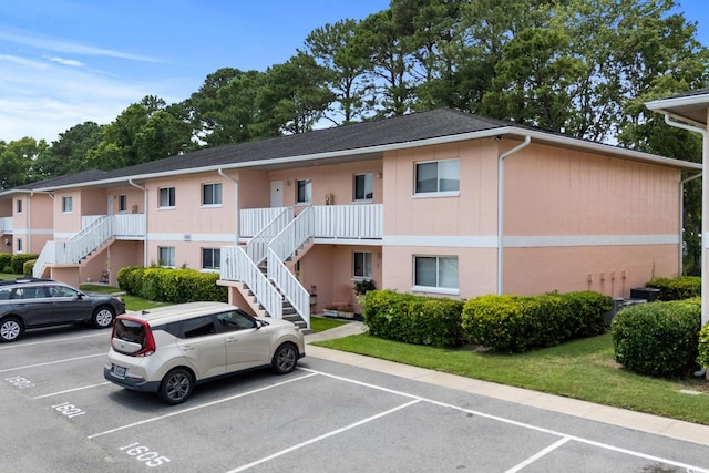 1101 2nd Ave N Unit 1501, Surfside Beach, SC 29575 - view of property featuring stairway and uncovered parking