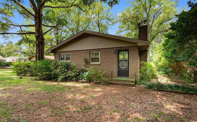1272 Park Hill Dr, Conway, SC 29526 - view of front of house featuring a chimney, brick siding, and entry steps