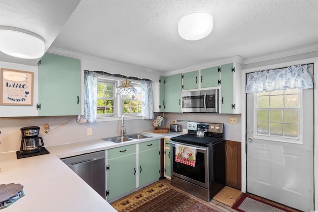 1272 Park Hill Dr, Conway, SC 29526 - kitchen with stainless steel appliances, light countertops, crown molding, a textured ceiling, and green cabinetry