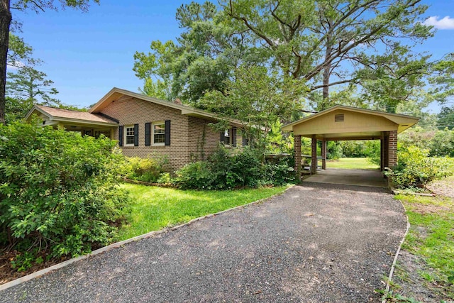 1272 Park Hill Dr, Conway, SC 29526 - view of property exterior with brick siding, driveway, a carport, and a lawn
