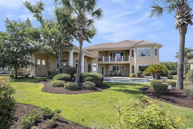 1503 Cadiz Dr, Myrtle Beach, SC 29579 - back of house with a balcony, stucco siding, a yard, and an outdoor pool