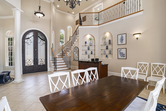 1503 Cadiz Dr, Myrtle Beach, SC 29579 - dining area with a high ceiling, ornamental molding, french doors, ornate columns, and built in features