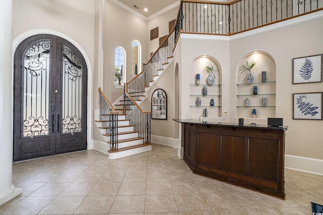 1503 Cadiz Dr, Myrtle Beach, SC 29579 - foyer with french doors, crown molding, a high ceiling, stairway, and arched walkways