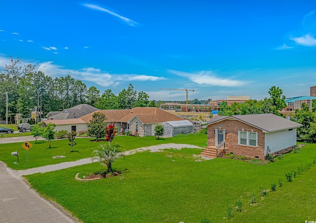 175 Cypress Ln, Little River, SC 29566 - view of front facade with brick siding, a front yard, driveway, and crawl space