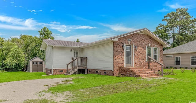 175 Cypress Ln, Little River, SC 29566 - back of property featuring crawl space, a storage unit, a yard, and a metal roof