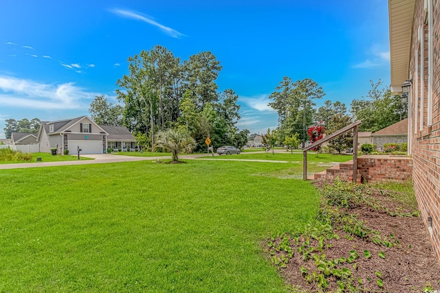 175 Cypress Ln, Little River, SC 29566 - view of green lawn featuring concrete driveway and a garage