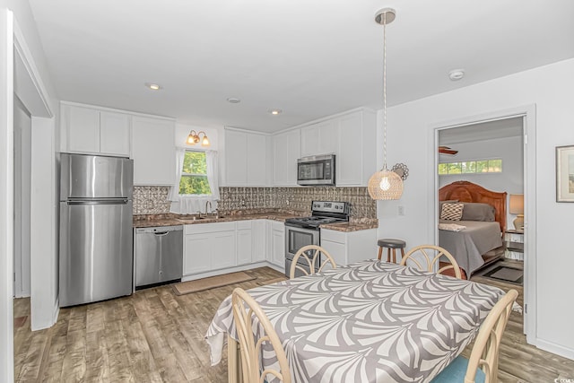 175 Cypress Ln, Little River, SC 29566 - kitchen featuring stainless steel appliances, light wood finished floors, white cabinets, backsplash, and recessed lighting