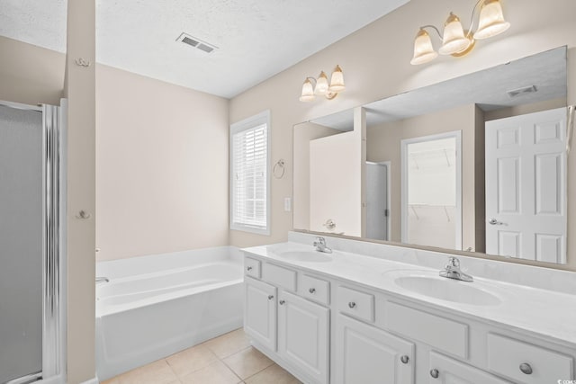 5008 Hayes Bay Ct, Murrells Inlet, SC 29576 - bathroom featuring a shower stall, double vanity, tile patterned floors, a garden tub, and a textured ceiling