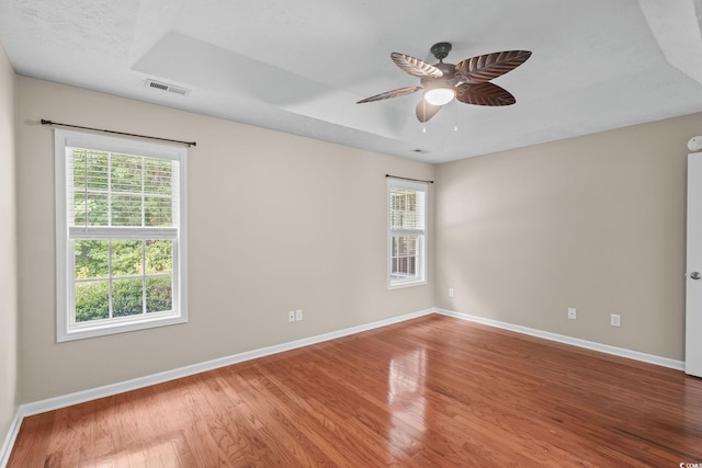 5008 Hayes Bay Ct, Murrells Inlet, SC 29576 - empty room with a tray ceiling, wood finished floors, and ceiling fan